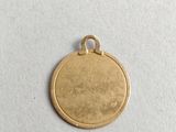 a gold coin with a small hole in the middle of it