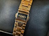 an image of a close up of a gold watch on a wrist