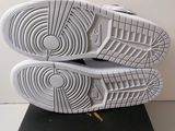 the sole of a pair of white shoes on top of a black surface
