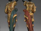two statues of a man and a woman are standing next to each other