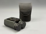 a close up of a camera and a case on a white surface