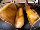 two leather seats in the back of a car
