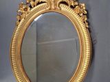 a gold mirror on the wall in the room