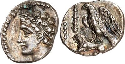 a silver coin with an eagle on top of it