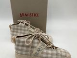 a pair of shoes with a box on a white surface