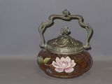 a small vase with a flower on it on a table