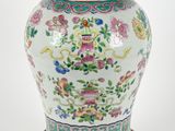 an image of a vase with a lid sitting on a wooden stand