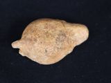 a small rock that is sitting on a black surface