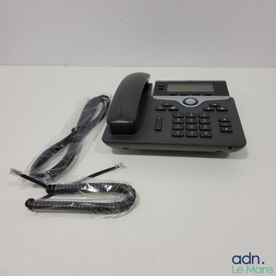 a telephone and a cord on a white table
