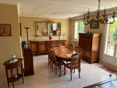 a dining room with a table and chairs and a chandelier