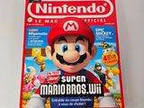 magazine cover of nintendo super mario bros wii on a white surface