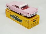 a pink toy car sitting on top of a yellow box