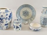 a group of blue and white vases and plates