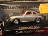 a silver toy car in a display case with a price tag
