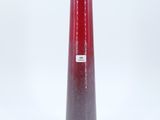 a red vase that is sitting on a white surface