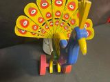 a toy peacock that is sitting on a table