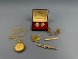 a box of gold jewelry on a table