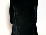 an image of a black dress on a mannequin stand