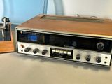a radio that is sitting on a table next to a record player