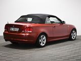 an image of a red convertible car parked on a checkered floor