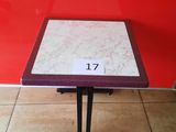 red and white table with a number on it in front of a red wall