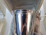 a silver cup that is sitting on top of a table