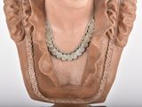 a bust of a woman with a necklace on it ' s neck