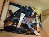 a cardboard box filled with assorted belts and other items