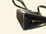 a black purse with a bow tie on it