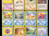several pokemon cards are displayed on a black surface