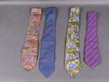 four different colored ties are lined up on a table