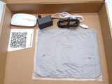 a box with a mouse, mouse pad, and other items in it