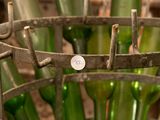 many green wine bottles in a metal basket