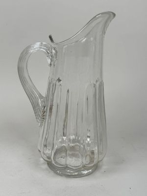a glass pitcher that is sitting on a table