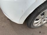 a close up of a white car with rust on the side of it
