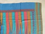 a close up of a colorful scarf on a white surface