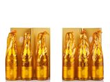 three bottles of gold colored liquid with a woman on them