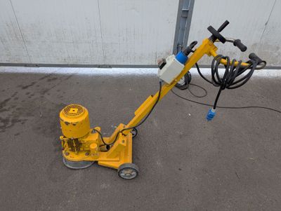 a yellow machine that is sitting on the ground