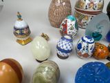many different vases on a table with a white background