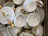 a lot of dishes and cups in a box