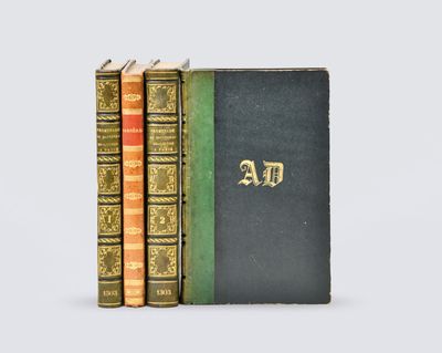 three books are stacked on top of each other on a white surface