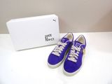 purple sued sneakers with crystal embellishments and a white box