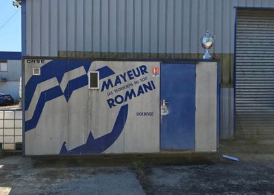 a blue and white sign on the side of a building