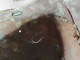a close up of a metal object with a hole in it