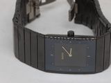 a watch that is sitting on a white surface