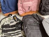 a lot of backpacks that are sitting on the floor