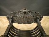 a wooden chair that has a carved back and seat