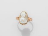 an image of a gold ring with a white stone in the center