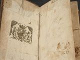 an open book with a drawing of a horse and a bird on it