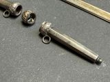 two silver objects sitting on a table next to each other